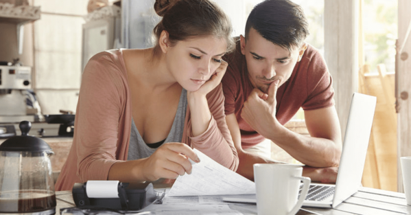 High Heating Bills This Winter – Check Your Attic Insulation.fw Couple looking at bills